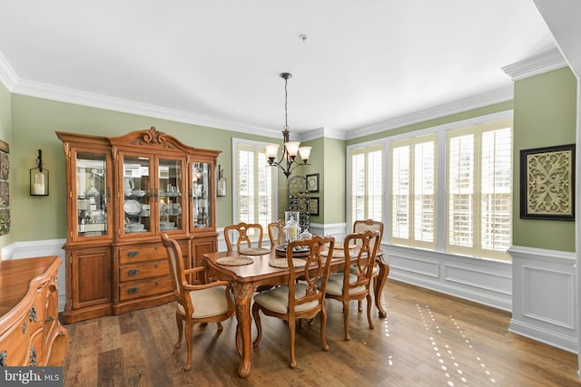 4108 Brushfield Dr, Frederick, MD 21704 - dining space featuring a chandelier, wainscoting, wood finished floors, crown molding, and a decorative wall