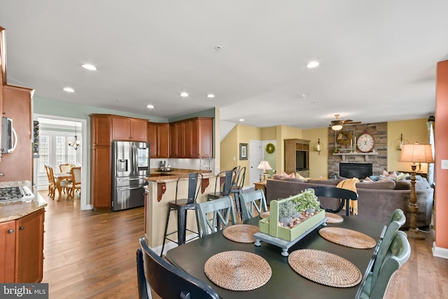 4108 Brushfield Dr, Frederick, MD 21704 - dining room with a fireplace, dark wood finished floors, a ceiling fan, and recessed lighting