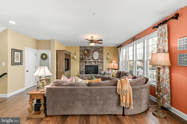4108 Brushfield Dr, Frederick, MD 21704 - living area featuring a ceiling fan, baseboards, a fireplace, and dark wood-style flooring