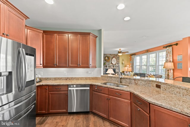 4108 Brushfield Dr, Frederick, MD 21704 - kitchen featuring appliances with stainless steel finishes, a sink, a ceiling fan, light stone countertops, and wood finished floors
