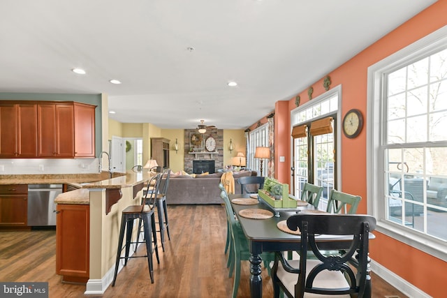 4108 Brushfield Dr, Frederick, MD 21704 - dining room featuring dark wood finished floors, a fireplace, recessed lighting, and baseboards