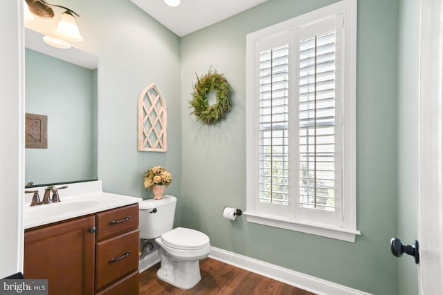 4108 Brushfield Dr, Frederick, MD 21704 - bathroom with baseboards, wood finished floors, toilet, and vanity