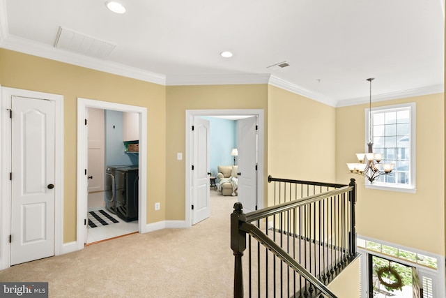 4108 Brushfield Dr, Frederick, MD 21704 - hallway featuring a chandelier, washing machine and dryer, light colored carpet, crown molding, and baseboards