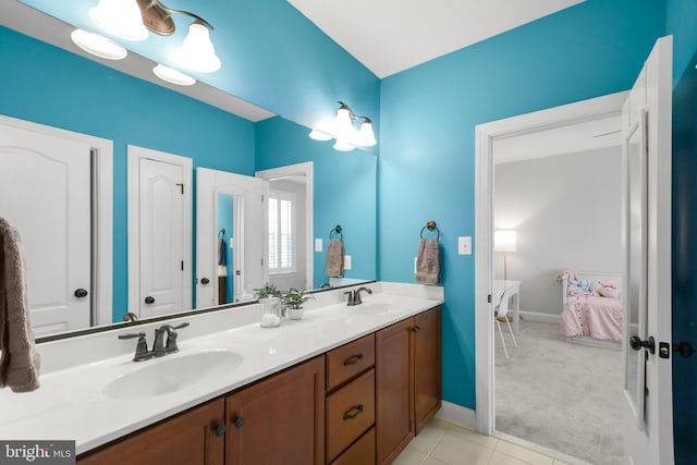 4108 Brushfield Dr, Frederick, MD 21704 - full bath with ensuite bath, double vanity, baseboards, and tile patterned flooring