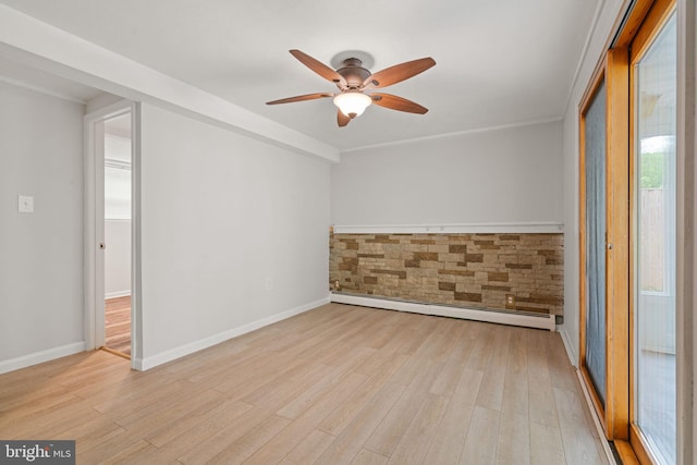 empty room featuring baseboard heating, ceiling fan, wood finished floors, and baseboards