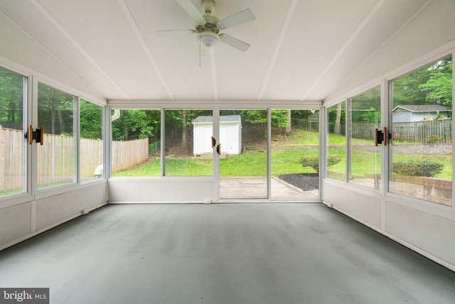 unfurnished sunroom featuring ceiling fan and vaulted ceiling