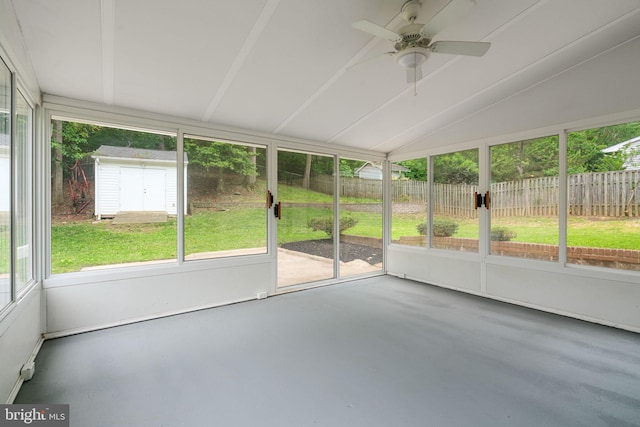 unfurnished sunroom with lofted ceiling and a ceiling fan