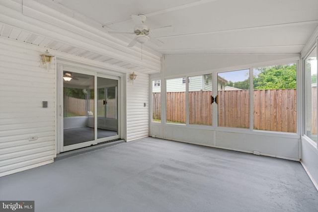 unfurnished sunroom with ceiling fan and lofted ceiling