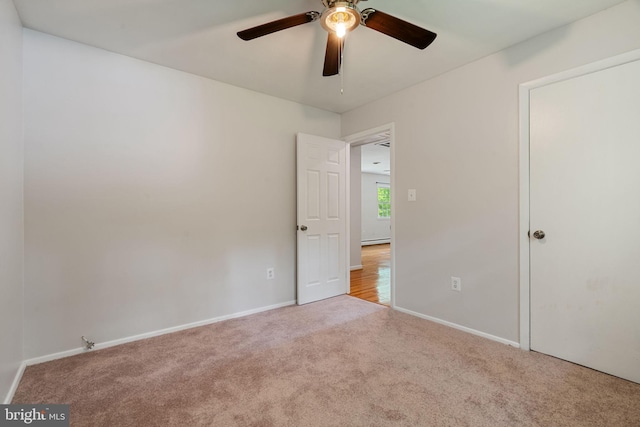 unfurnished bedroom with carpet flooring, baseboards, and a ceiling fan