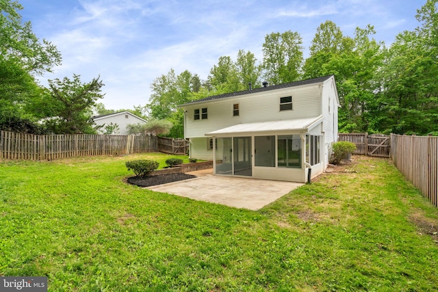 rear view of property with a sunroom and a patio area