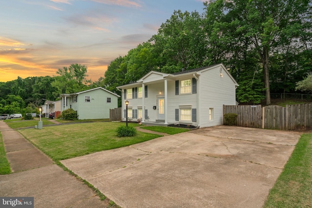 bi-level home with covered porch and driveway