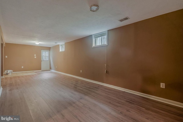 below grade area featuring wood finished floors and baseboards