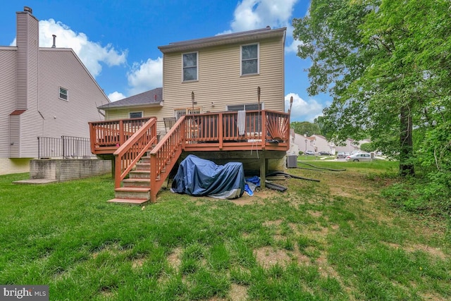 back of house with a yard, a wooden deck, and central air condition unit
