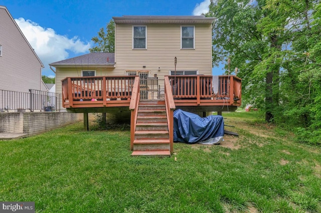 back of house featuring a deck and a yard