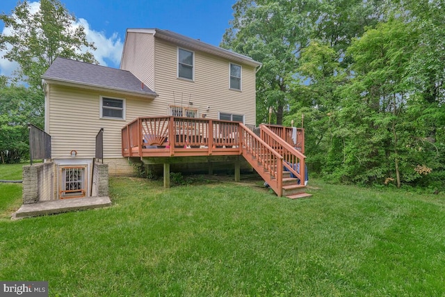 rear view of house featuring a wooden deck, a lawn, and stairway