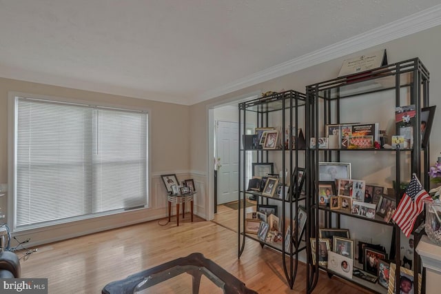 miscellaneous room featuring wood finished floors and crown molding