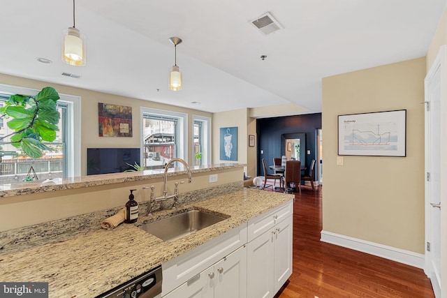 1811 Chestnut St Unit 405, Philadelphia, PA 19103 - kitchen with a sink, wood finished floors, pendant lighting, white cabinetry, and light stone counters