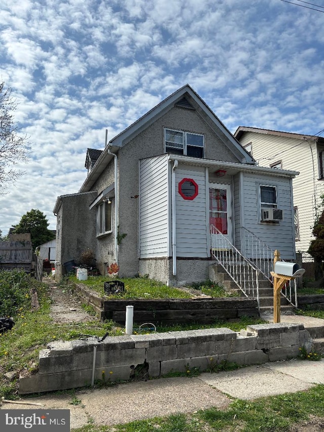 view of front of property with entry steps and cooling unit