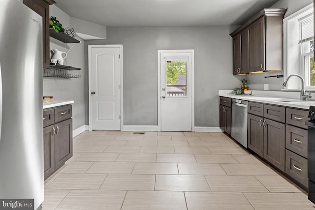 kitchen featuring appliances with stainless steel finishes, open shelves, light countertops, and plenty of natural light