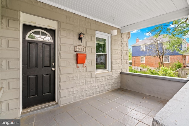 property entrance with stone siding and covered porch