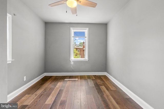 unfurnished room featuring wood-type flooring, ceiling fan, and baseboards