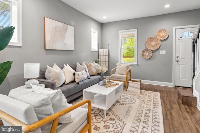 living room featuring dark wood-style floors, recessed lighting, and baseboards