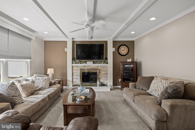 carpeted living room with ceiling fan, a stone fireplace, beam ceiling, recessed lighting, and crown molding
