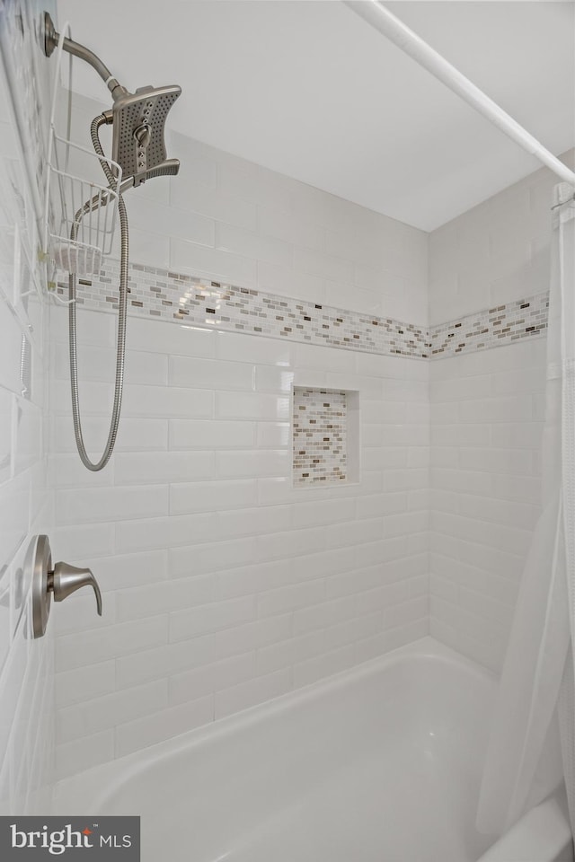 bathroom with shower / bath combo with shower curtain