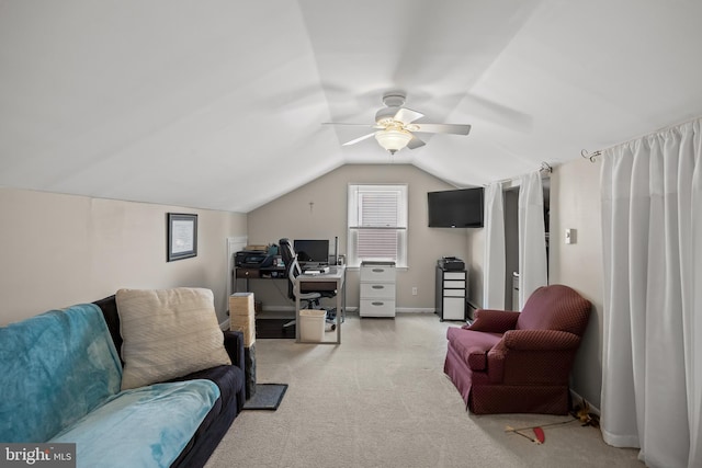 living area featuring a desk, light carpet, ceiling fan, and lofted ceiling
