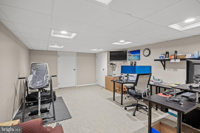 carpeted home office featuring a paneled ceiling and baseboards