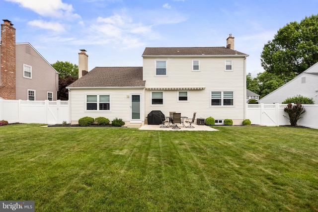 rear view of property featuring a chimney, a patio, a gate, and roof with shingles