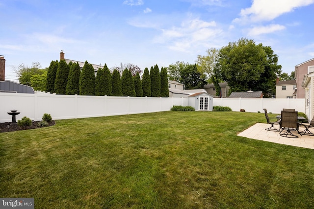 view of yard with a patio area and an outbuilding