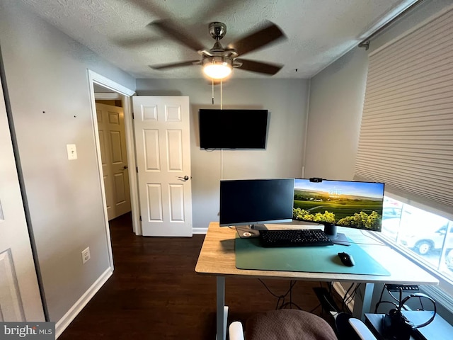 home office featuring ceiling fan, baseboards, wood finished floors, and a textured ceiling