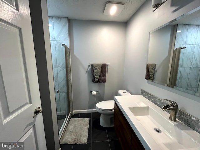 full bathroom featuring a stall shower, tile patterned flooring, vanity, toilet, and baseboards