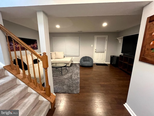 living room featuring dark wood finished floors, stairs, recessed lighting, and baseboards