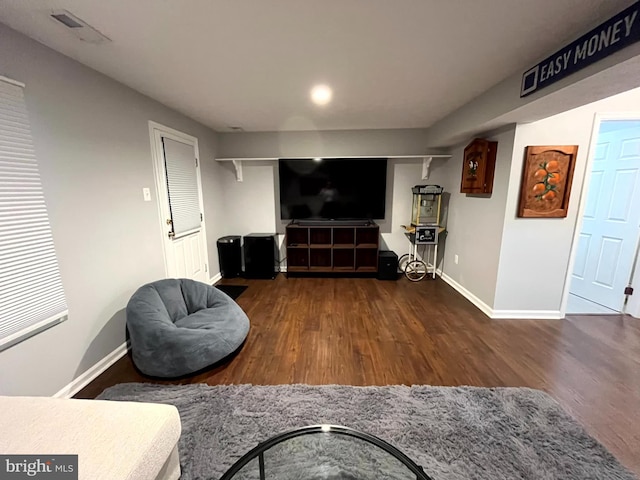 living area with wood finished floors and baseboards