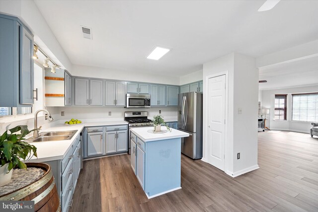 146 Connery Ter SW, Leesburg, VA 20175 - kitchen with stainless steel appliances, a sink, a center island, light countertops, and dark wood finished floors