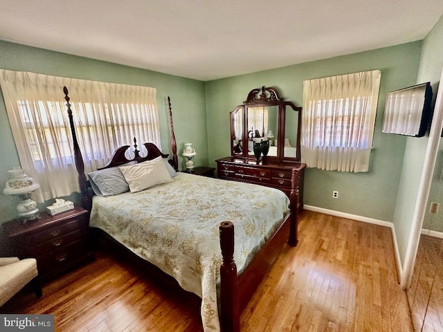 bedroom featuring wood finished floors and baseboards