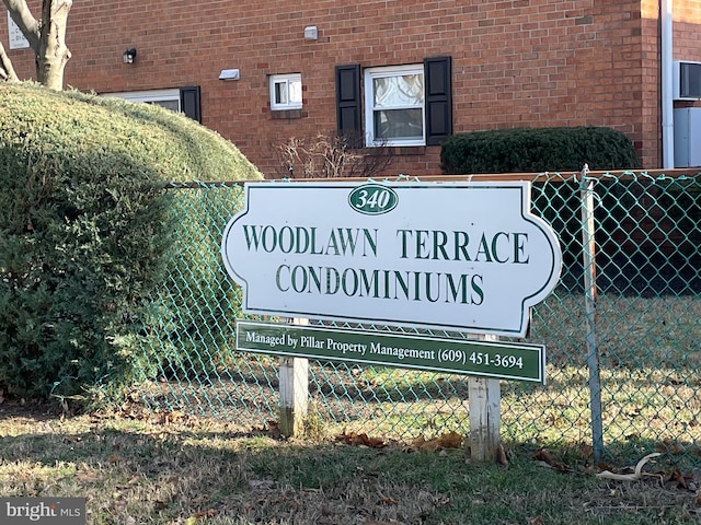 community sign featuring fence