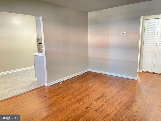 empty room with wood finished floors and baseboards