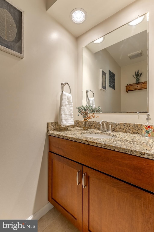 bathroom with tile patterned flooring, vanity, and baseboards