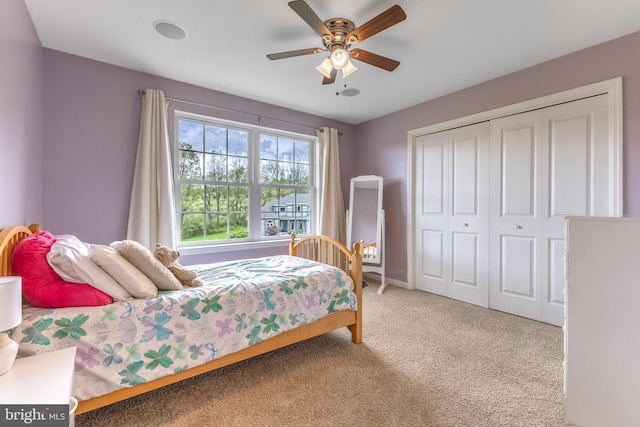 bedroom with carpet floors, a closet, a ceiling fan, and baseboards