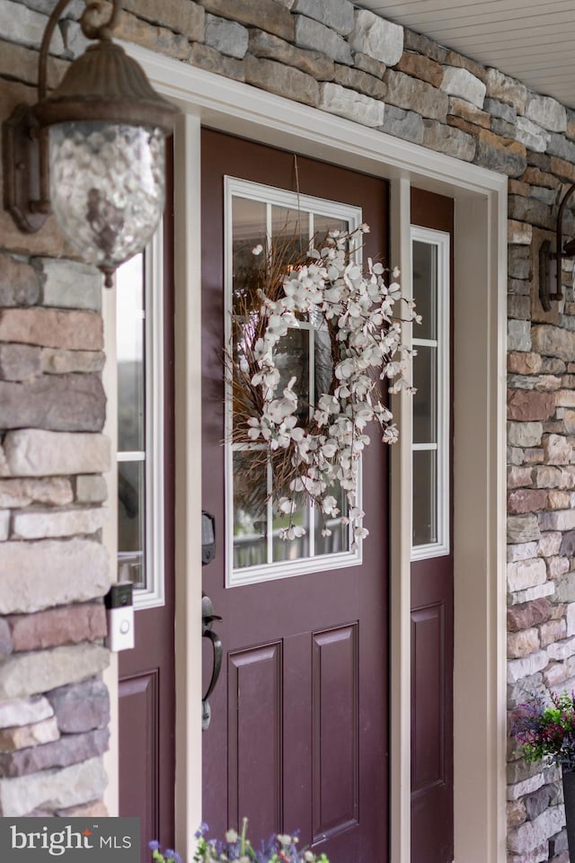 entrance to property with stone siding
