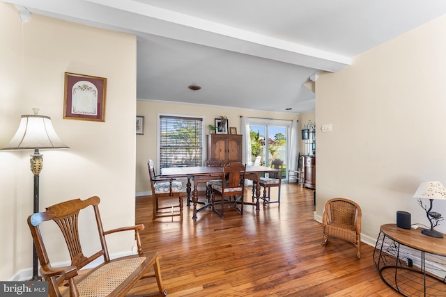 dining space featuring wood finished floors and baseboards