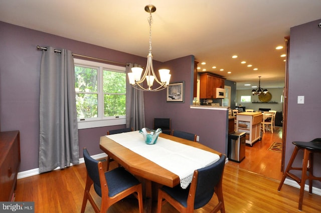 dining area featuring a chandelier, recessed lighting, light wood finished floors, and baseboards