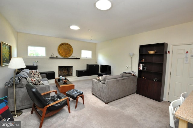 living room featuring light colored carpet and a fireplace