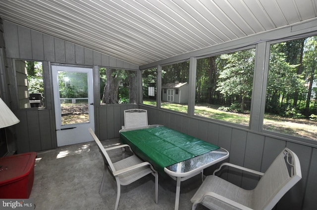 sunroom / solarium featuring lofted ceiling and outdoor dining space