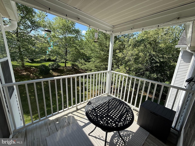 wooden deck featuring view of wooded area