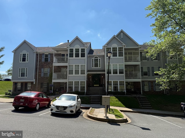 view of property featuring uncovered parking