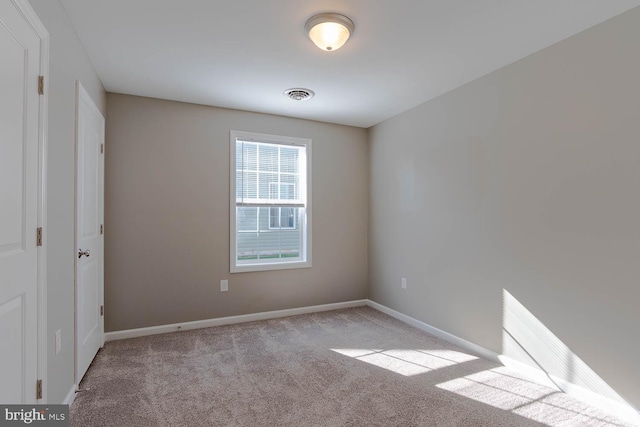 unfurnished room with carpet and baseboards